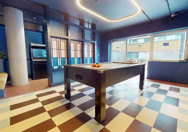 Pool table arcade game and checkered floor common area at iQ Highbury in London Student Accommodation
