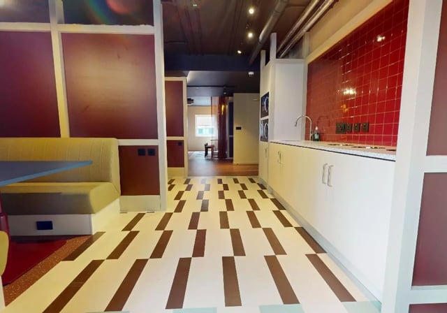 Booth seating and modern kitchen area kitchen at iQ Highbury in London Student Accommodation