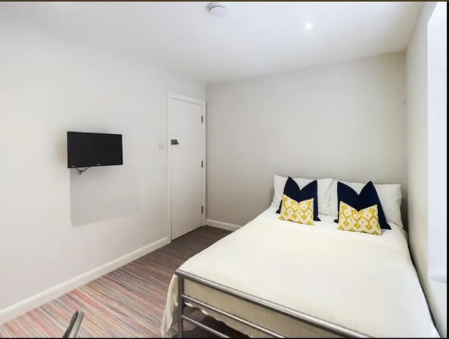 Bed TV and pillows bedroom at 48 Ashford Street in Stoke-On-Trent Student Accommodation