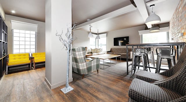 Chairs sofa table bar stools television living room at Marketgait Apartments in Dundee Student Accommodation