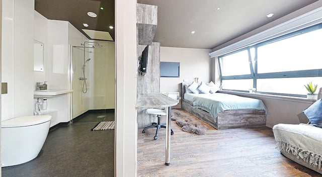 Bed desk chair and shower bathroom bedroom at Marketgait Apartments in Dundee Student Accommodation