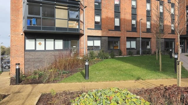 Brick building with lawn and pathway exterior at Collegiate Riverside Way Winchester in Winchester Student Accommodation