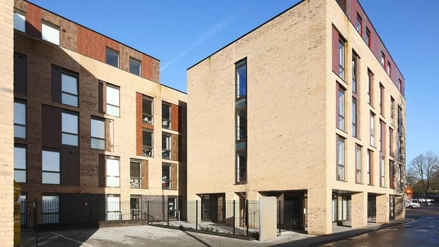 Modern brick student accommodation buildings with blue sky exterior at Collegiate Cathedral Point in Winchester Student Accommodation