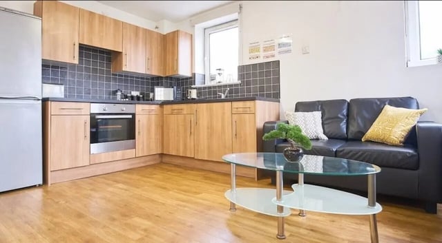 Kitchen with sofa and coffee table living room at Manchester House in Manchester Student Accommodation