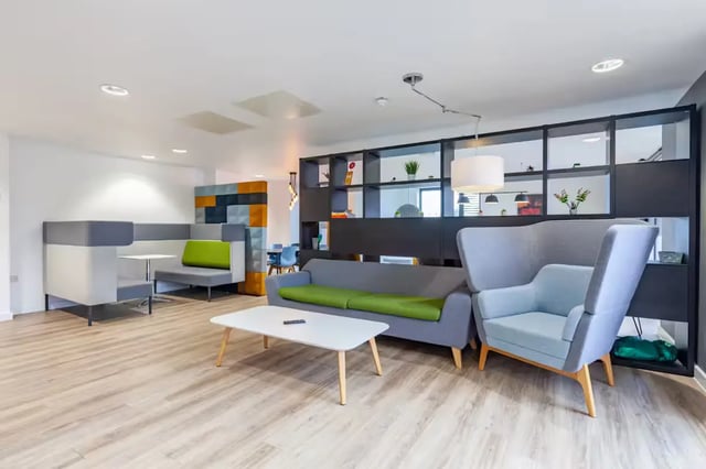 Modern lounge with sofas chairs and booths living room at Atlas House in Exeter Student Accommodation