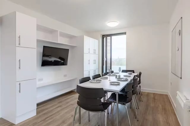 Dining area with table chairs and television communal area at Atlas House in Exeter Student Accommodation