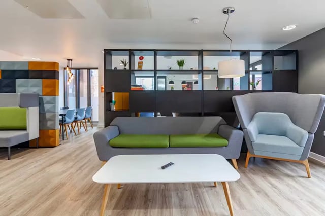 Modern living room with sofas armchair coffee table living room at Atlas House in Exeter Student Accommodation