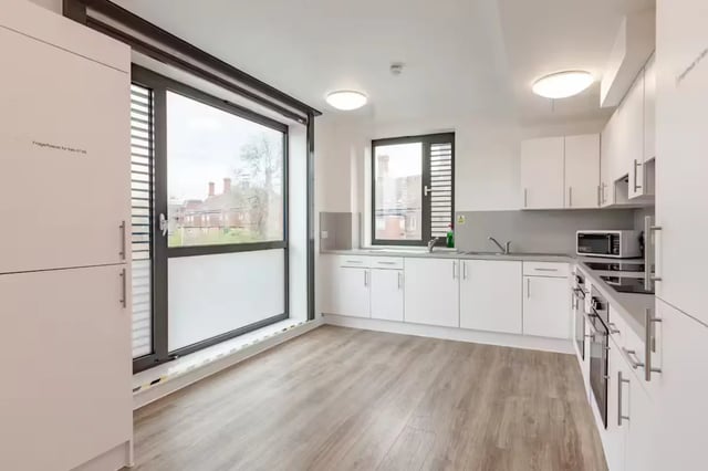 Modern white kitchen with appliances and large window kitchen at Atlas House in Exeter Student Accommodation