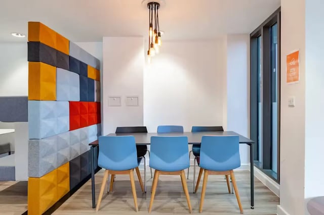 Table chairs and decorative wall common area at Atlas House in Exeter Student Accommodation