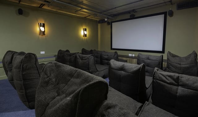 Beanbag chairs and projection screen in cinema room at St Peter's Hall in Bournemouth Student Accommodation