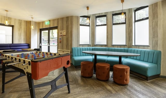 Foosball table booths and stools communal area at St Peter's Hall in Bournemouth Student Accommodation