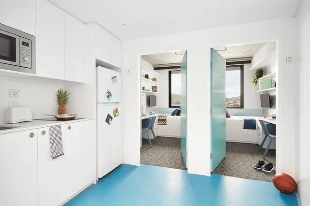 Kitchen area with beds and desks bedroom at Scape Toowong in Brisbane Student Accommodation