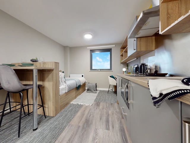 Bed kitchen table with chairs studio apartment at Justice Mill Studios in Aberdeen Student Accommodation