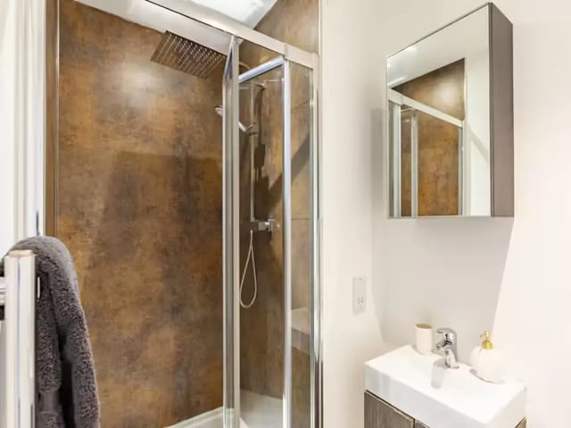 Modern shower cubicle sink and mirror bathroom at Redvers Tower in Sheffield Student Accommodation