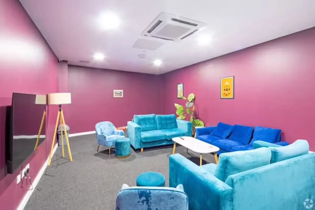 Turquoise couches, armchair, coffee table, television living room at The Paper Works in Sheffield Student Accommodation