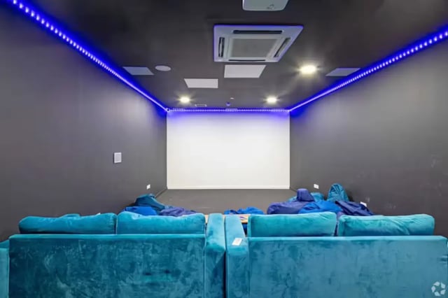 Blue sofas and beanbags facing projection screen movie room at The Paper Works in Sheffield Student Accommodation