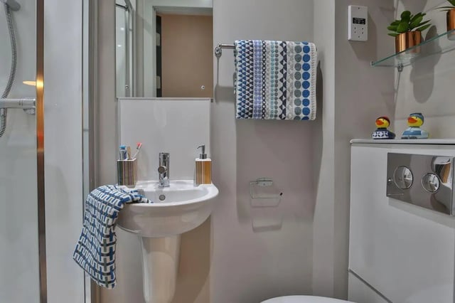 Sink toiletries towel rack toilet cistern bathroom at George Street Apartments in Glasgow Student Accommodation