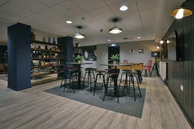 Tables stools plants foosball table common room at George Street Apartments in Glasgow Student Accommodation