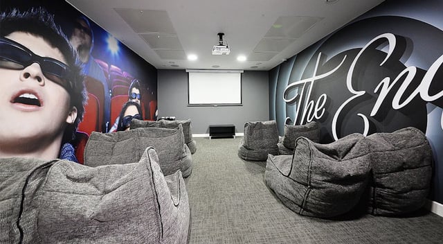 Beanbag chairs surround projector screen cinema room at 88 Bromsgrove House in Birmingham Student Accommodation