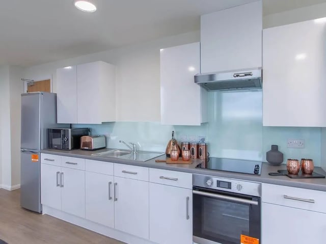 Modern kitchen with stainless steel appliances and white cabinets kitchen at Bridge Street Exchange in Cardiff Student Accommodation