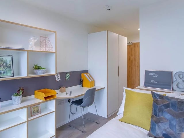 Desk chair shelves and bed bedroom at Bridge Street Exchange in Cardiff Student Accommodation