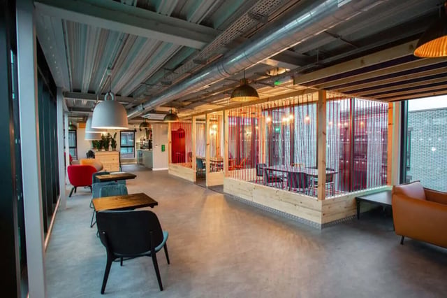 Seating booths and tables with chairs lounge area living room at Steel City in Sheffield Student Accommodation