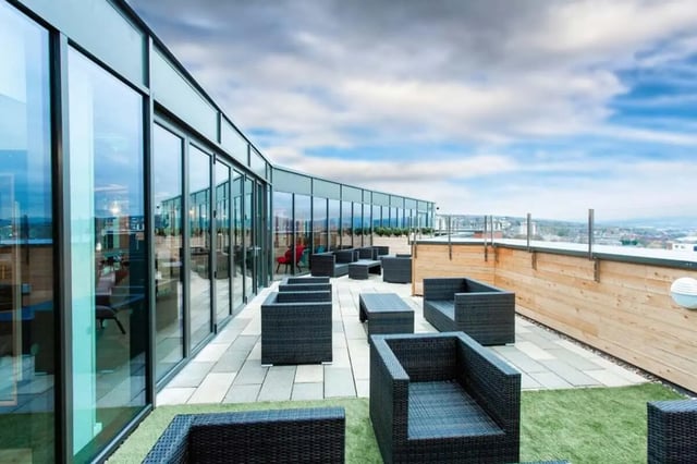Wicker seating area with tables outside building exterior at Steel City in Sheffield Student Accommodation