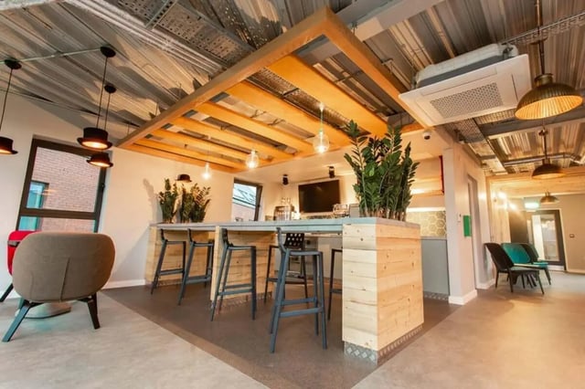 Bar area with stools plants and chairs common area at Steel City in Sheffield Student Accommodation