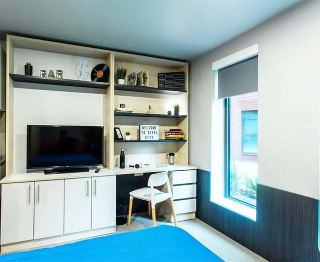 Bed with TV desk shelves and window bedroom at Steel City in Sheffield Student Accommodation