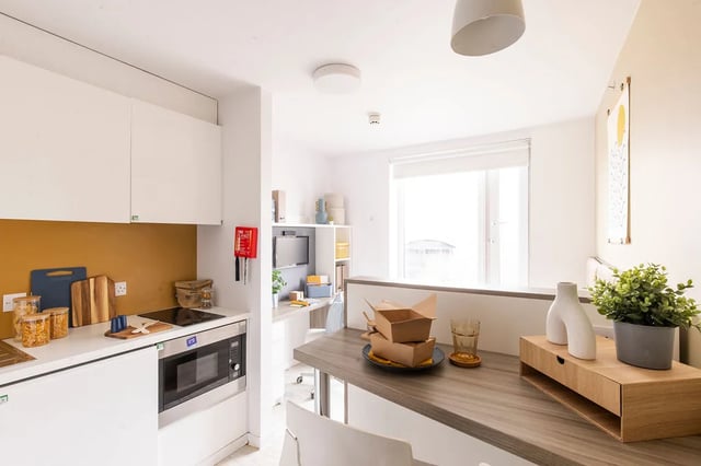 Kitchen area with microwave and stove kitchen living area at Merlin Point in Coventry Student Accommodation