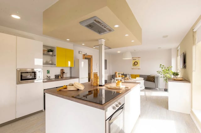 Kitchen island microwave oven and sofa living room at Merlin Point in Coventry Student Accommodation