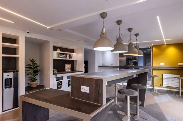 Communal tables pendant lights and stools communal area at Merlin Point in Coventry Student Accommodation