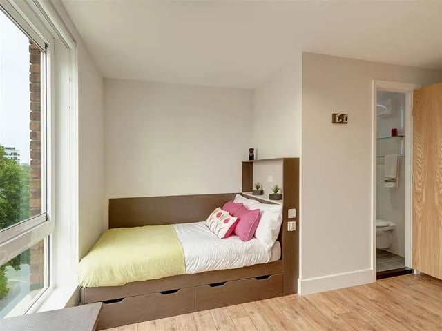 Bed with drawers shelving and bathroom bedroom at Davidson House in Kingston Upon Thames Student Accommodation