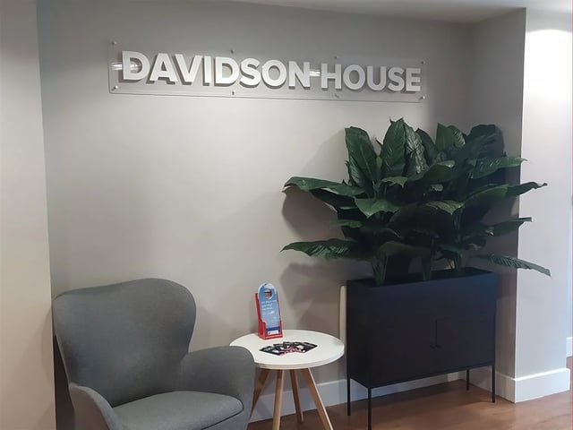 Davidson House signage grey armchair plant reception area at Davidson House in Kingston Upon Thames Student Accommodation
