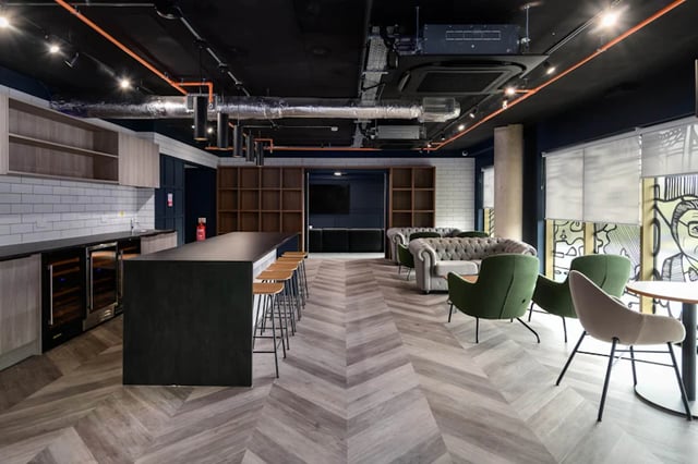 Kitchen island bar with stools sofas chairs common room at Stanley Studios in Southampton Student Accommodation