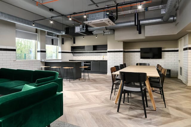 Green sofa kitchen island dining table common area at Stanley Studios in Southampton Student Accommodation