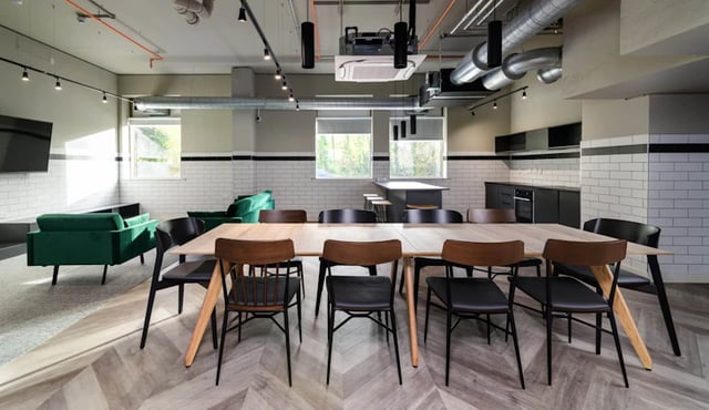 Dining table and chairs with lounge area kitchen living room at Stanley Studios in Southampton Student Accommodation