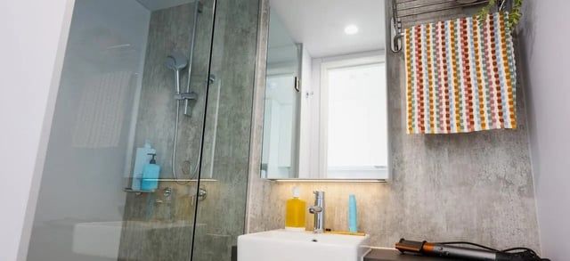 Shower sink mirror bottles and towel bathroom at Scape Leicester in Melbourne Student Accommodation