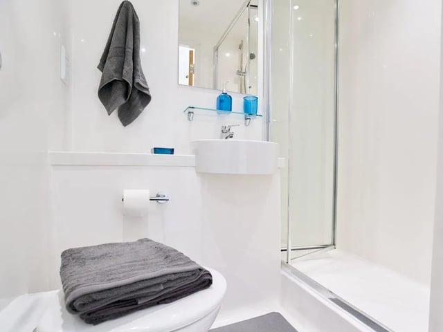 Toilet sink shower and towels bathroom at The Lantern in Liverpool Student Accommodation