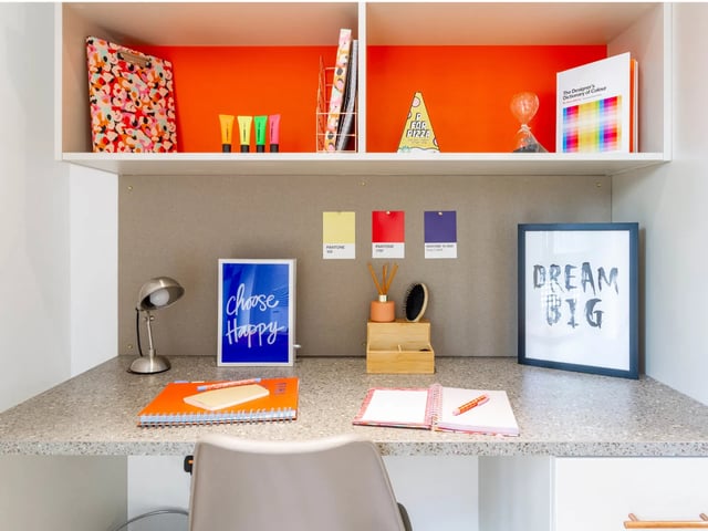 Desk with lamp notepad and inspirational art study area at The Lantern in Liverpool Student Accommodation