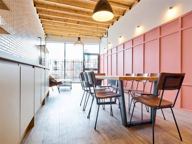 Wooden table chairs white cabinets modern communal area dining room at The Lantern in Liverpool Student Accommodation