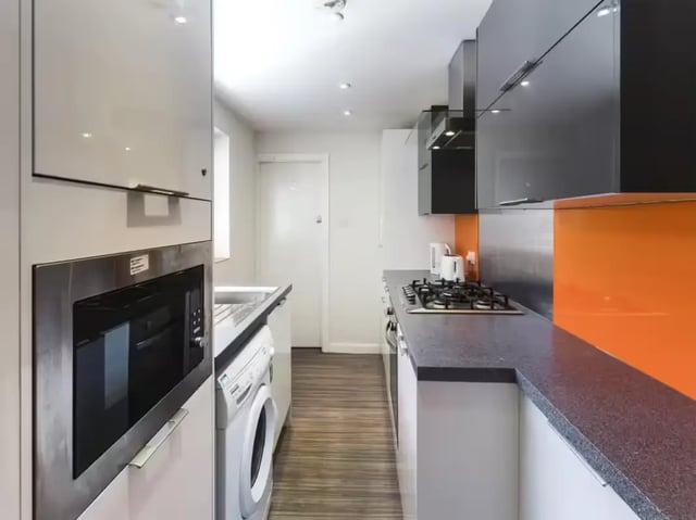 Modern kitchen with microwave washing machine stove kitchen at 24 Seaford Street in Stoke-On-Trent Student Accommodation