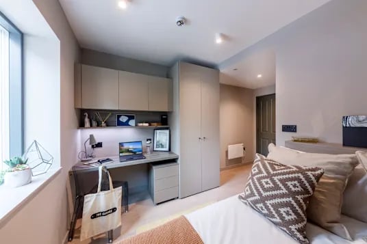 Desk laptop wardrobe and bed bedroom at The Garage Egham in Egham Student Accommodation
