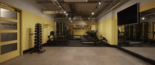 Gym equipment weights treadmills and mirrors playing area at The Garage Egham in Egham Student Accommodation