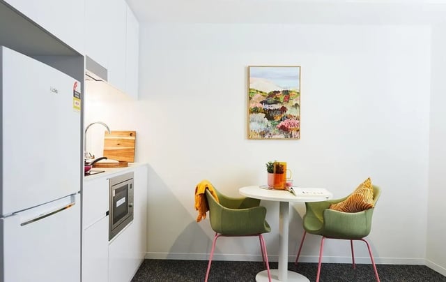 Fridge sink microwave painting dining table kitchen at Scape Darlington in Sydney Student Accommodation