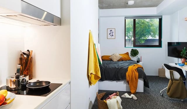 Kitchen cooking area with bed and study area at Scape Darlington in Sydney Student Accommodation