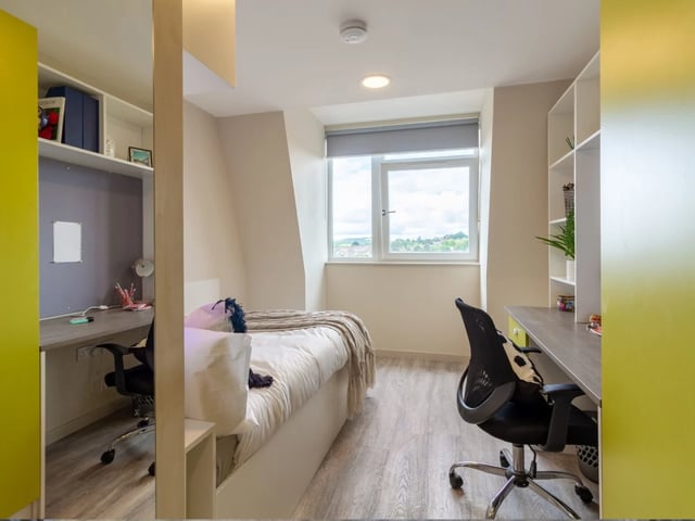 Bed desks chairs shelves window bedroom at The Barn in Exeter Student Accommodation