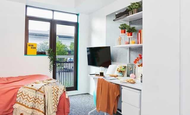 Bed desk shelves plants and television bedroom at Scape Darlington in Sydney Student Accommodation