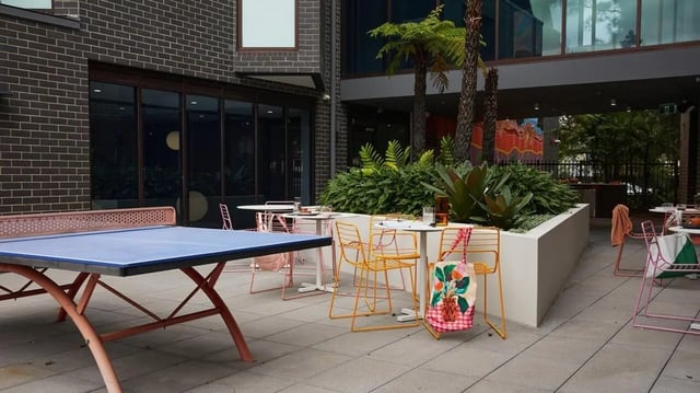 Ping pong table chairs tables and plants exterior at Scape Darlington in Sydney Student Accommodation