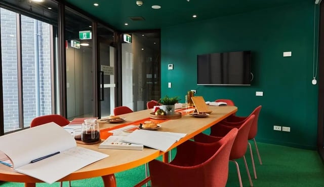 Table with red chairs and books study area at Scape Darlington in Sydney Student Accommodation